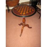 A small tripod pedestal table with inlaid chess board top