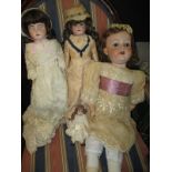 Four antique bisque head dolls