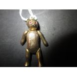 A 9ct gold teddy bear with gem set eyes