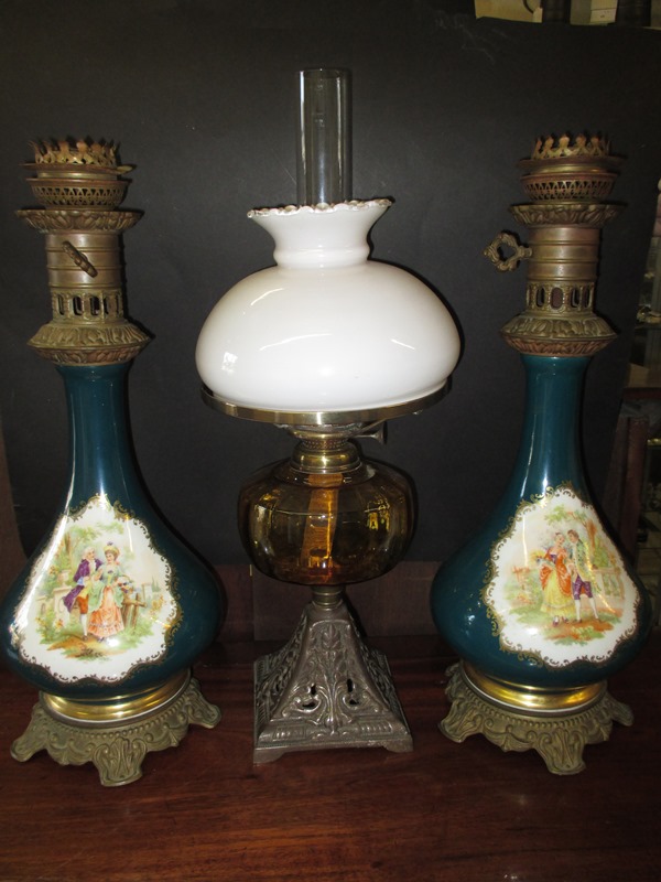 An Edwardian oil lamp and two ceramic electric lamp bodies