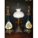 An Edwardian oil lamp and two ceramic electric lamp bodies