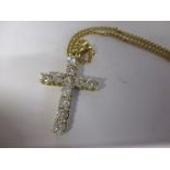 An 18ct gold cross mounted with 11 diamonds, approx 3ct of diamonds