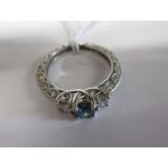 A 9ct gold ring set with 2 diamonds and central blue stone