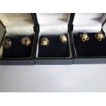 Three pairs of gold earrings in original retailers boxes