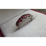 A 9ct white gold ring set with five rubies