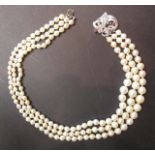 A 3 string graduated pearl necklace with Art Deco style platinum clasp set with rubies and approx 70