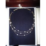 An 18ct yellow gold and pearl choker in original retailer’s box