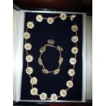 A gilt sterling silver necklace and bracelet set, in the form of a daisy chain in original