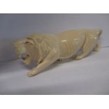 An early 20th century Nigerian carved ivory figure of a roaring lion, approx 23cm