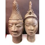 Two antique Benin cast bronze heads of an Oba and an Iyoba