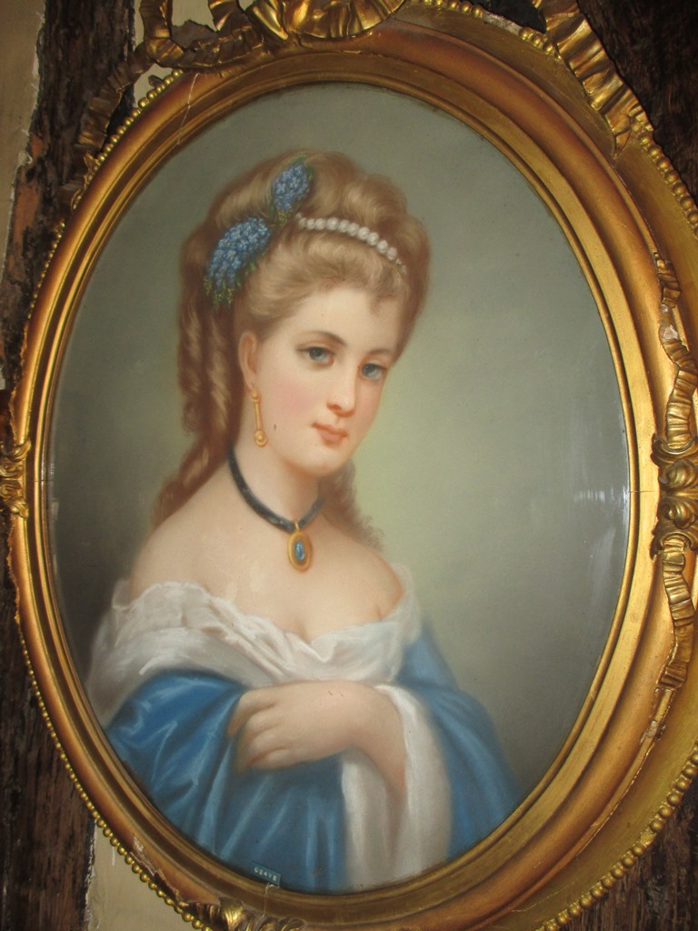 A 19th Century, pastel portrait in a gilt ribbon topped oval frame