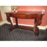 A 19th century mahogany side table with central frieze drawer and carved front legs to under tier