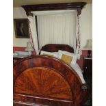 An early 19th century flame mahogany half tester double bed