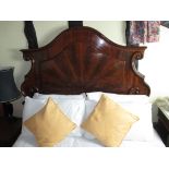 A continental mahogany double bed with scrolled headboard