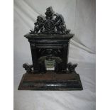 A cast iron door stop in the form of an Adams style fire place, with royal crest