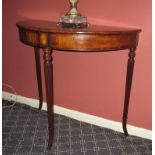 A Demilune side table with reeded legs