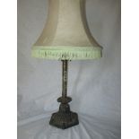 A cast iron and brass decorative table lamp