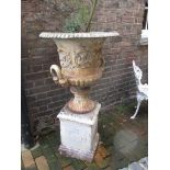 A cast iron garden urn with base