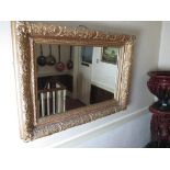 A large gilt framed wall mirror