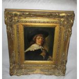 A gilt framed painting on tin of a cavalier