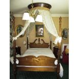 An antique 4 poster bed with French canopy