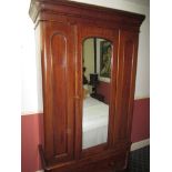 A 19th century single mahogany wardrobe with mirrored door and base drawer unit