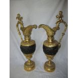 A large pair of bronze ormolu decorative jugs, with cherubs