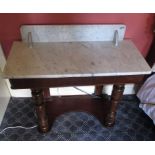 A Victorian mahogany marble top washstand with turned front columns