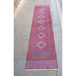 A vintage Afghan runner with central lozenge design