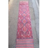 A vintage Afghan runner with central geometric double lozenge design