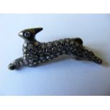 A Silver Rabbit With Yellow Metal Pin Encrusted In Diamonds