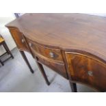 An Edwardian Serpentine Mahogany Sideboard