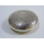 A Silver Circular Box With Chased Decor