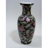 An Oriental Enamelled Vase On Black Ground