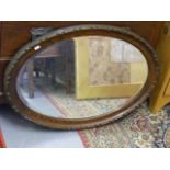 An Oak Framed Oval Mirror