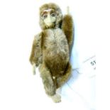 Early 20th Century brown plush and felt monkey, probably Schuco, having a metal face, lever to his