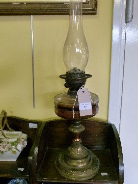 Late 19th/early 20th Century oil lamp having facet cut clear glass reservoir on a gilt metal