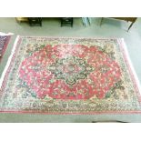 Modern Middle Eastern rug decorated with a central medallion on a red ground within multi borders