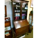 1920's period bureau bookcase, the upper section having blind fretwork frieze, two astragal glazed