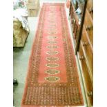 Modern Middle Eastern style runner decorated with a series of medallions on a red ground within