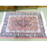 Good quality modern Middle Eastern rug decorated with a central medallion on a red ground within