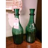 Pair of 19th Century green glass carafes, each having vertical cut decoration