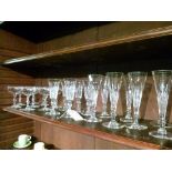 Collection of good quality cut glass Champagne flutes and glasses (one shelf)