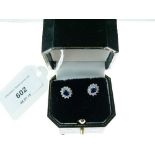 Pair of hallmarked 18ct white gold earrings set oval blue stones surrounded by white stones