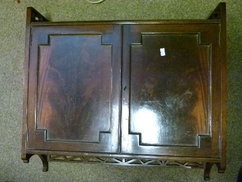 Late 19th Century mahogany wall mounted cupboard having pierced Chinese rail crest, fitted two blind