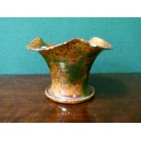 Ewenny Pottery mottled green and brown glazed vase having a flared neck and standing on a circular