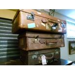 Two vintage leather suitcases and one other suitcase