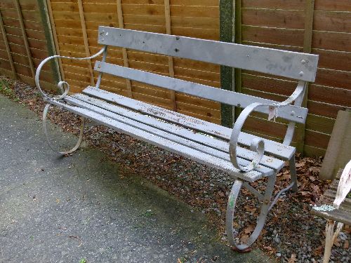 Late 20th Century slatted garden bench having cast iron ends