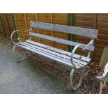 Late 20th Century slatted garden bench having cast iron ends