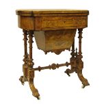 Victorian inlaid walnut and figured walnut games/work table, the fold over top opening to reveal